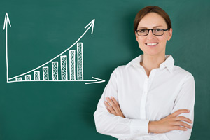 woman with glasses in front of an upward trend graph