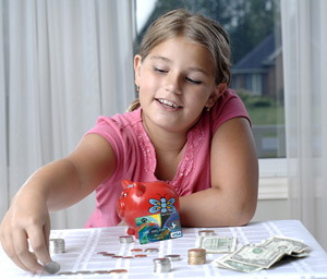 Kid counting money on table