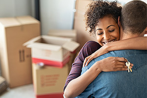 Woman and man embrace after moving into new home