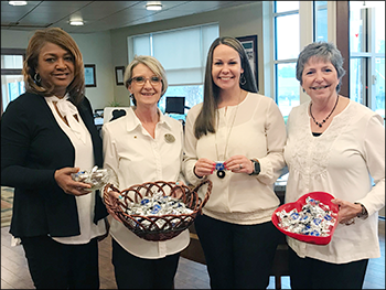 employees with baskets of treats for customers